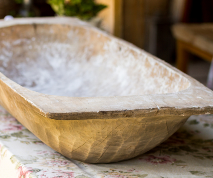 vintage wooden dough bowl on table