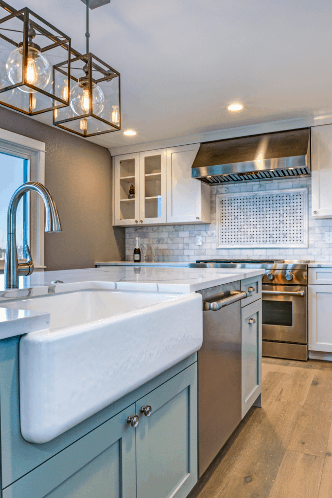 modern farmhouse kitchen with blue cabinets and a white farmhouse sink