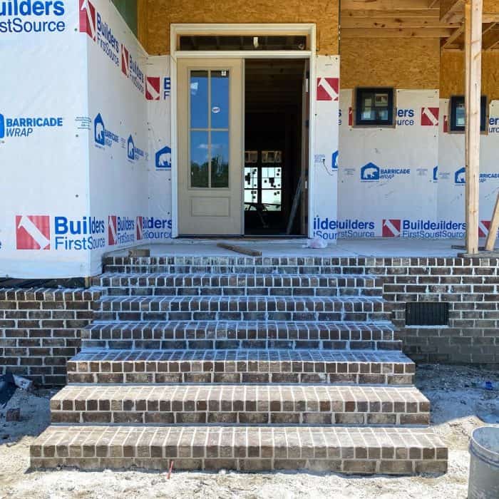 Brick Steps on front porch of modern farmhouse new build