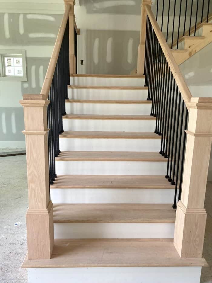 staircase with black metal and red oak
