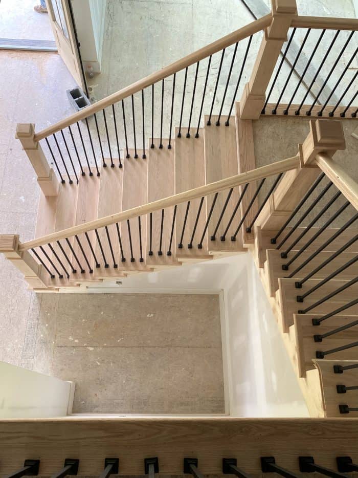 L shaped staircase with red oak newel posts