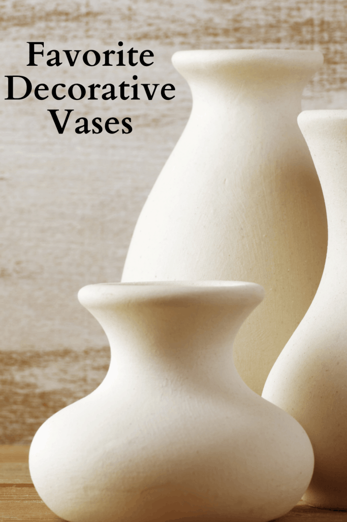 three decorative vases that are beige and different sizes