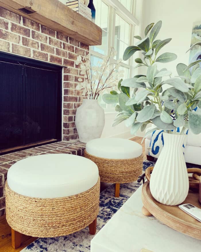 ottomans in front of brick fireplace