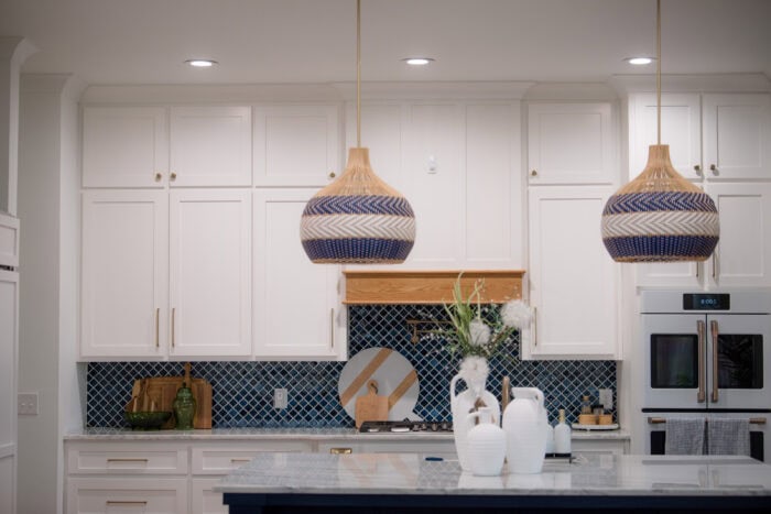 kitchen pendant lights over island with cabinets in the back
